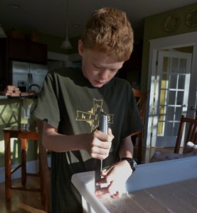 Sean cuts a batch of oatmeal soap into bars.